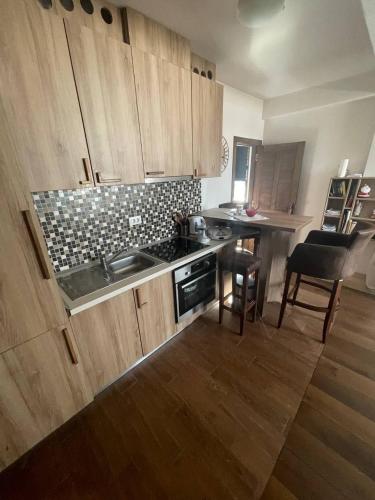 a kitchen with a sink and a stove top oven at Vidik Kopaonik in Kopaonik