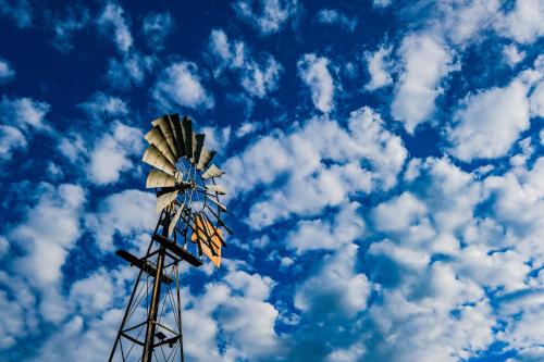 a windmill against a blue sky with clouds at Rose Acres Guest House in Parys