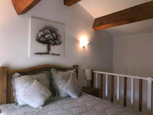 a bedroom with a bed with a tree on the wall at Appartements de Charme in Corte