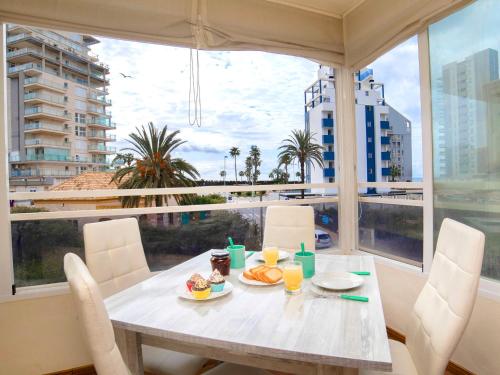 a table with food on it in a room with a window at Apartment Saladar-1 by Interhome in Calpe
