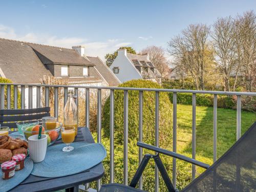 a table with food and drinks on a balcony at Apartment Les Ecureuils by Interhome in Carnac