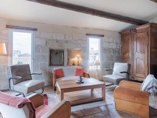 a living room with a couch and chairs and a table at Holiday Home La Maison Theaulon by Interhome in Aigues-Mortes