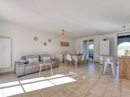 a living room with a couch and a table at Holiday Home Lou Cepoun by Interhome in Cogolin
