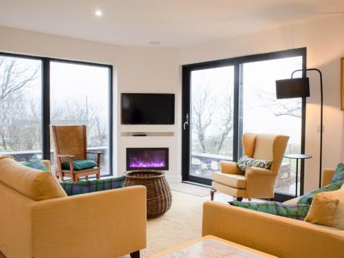 a living room with two couches and a fireplace at Holiday Home 10 Husabost by Interhome in Husabost