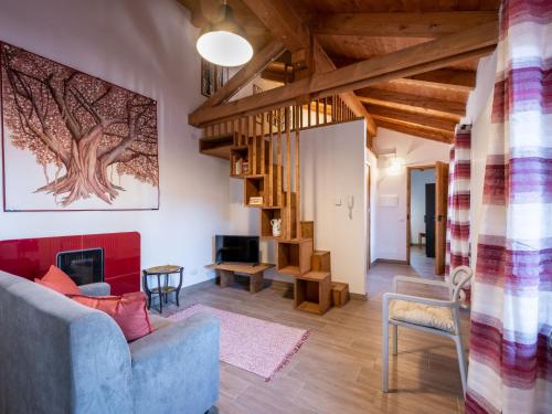 a living room with a blue couch and a fireplace at Apartment Il Tiglio by Interhome in Mondovì