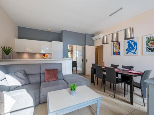 a living room and kitchen with a couch and a table at Apartment Villa Francia-2 by Interhome in Cannes