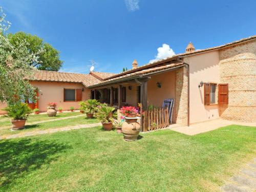 a house with a yard with potted plants at Holiday Home Villastrada by Interhome in Villastrada