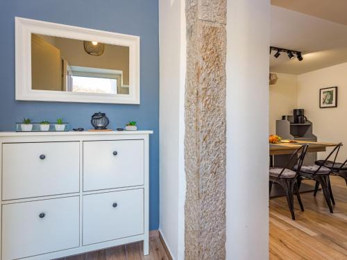 a room with a white dresser and a mirror at Holiday Home Hamara by Interhome in Potpićan
