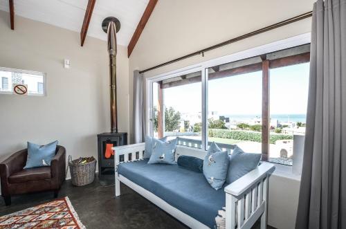 a room with a blue couch and a window at Sea La Vie in Yzerfontein