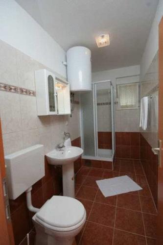 a bathroom with a toilet and a sink at Apartments Villa Bayview in Trogir