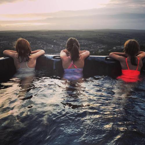 a group of three women sitting in a hot tub at The Coach House & The Stables Yorkshire Peak District With and without hot tub options in Wortley