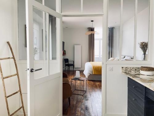 a kitchen with a door leading to a bedroom at La Cour Tellier in Rilly-la-Montagne