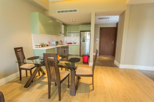 a kitchen and dining room with a table and chairs at Accra Luxury Apartments @ Pearl in Accra