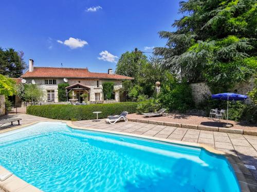 a large swimming pool in front of a house at Les Grozilles in Feuillade