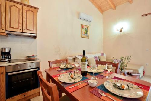 a kitchen with a table with a bottle of wine at Sunset Cottage in Paramonas