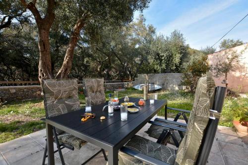 a black table and chairs on a patio at Sunset Cottage in Paramonas