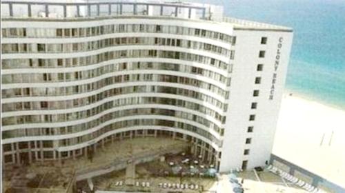 a large building on the beach next to the ocean at Hotel Apartment Short Term Tel Aviv Bat Yam 5 in Bat Yam