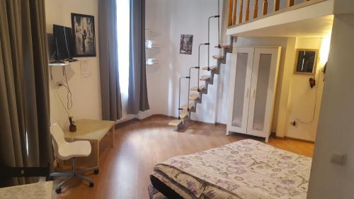 a room with a bed and a desk and stairs at Studio Piata Amzei NR.1 (8 B) in Bucharest