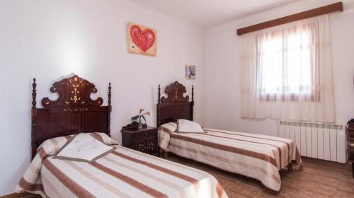 Postel nebo postele na pokoji v ubytování Sa Gravera de Sa Barrala