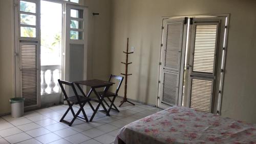 a bedroom with a table and chairs and a bed at Bela Vista in São Luís