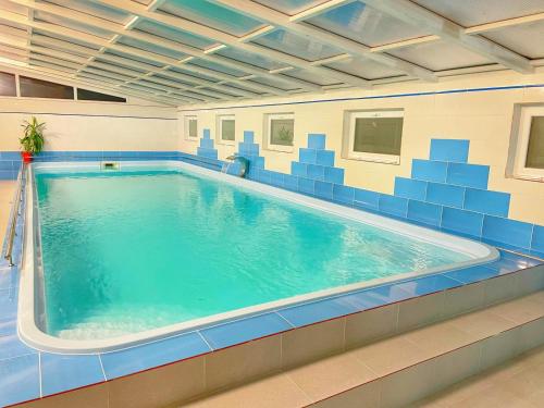 a large swimming pool in a building at Hotel Gâlma in Moroeni