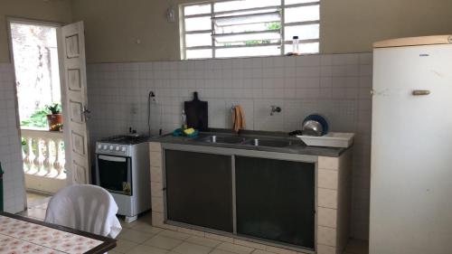 a kitchen with a sink and a stove at Bela Vista in São Luís