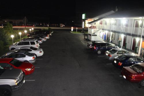 a row of cars parked in a parking lot at night at Liberty Inn Absecon Atlantic City in Galloway