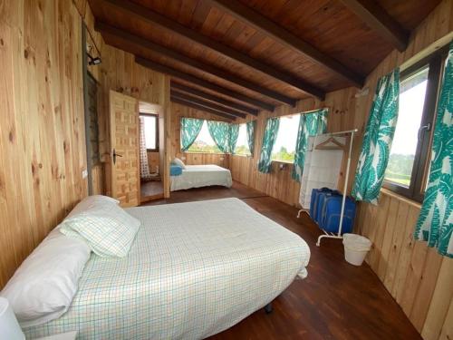 a bedroom with a bed in a wooden cabin at Ak-55 Rural House in Villaviciosa