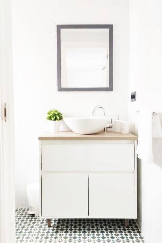 a white bathroom with a sink and a mirror at Marbella Center Apartment in Marbella