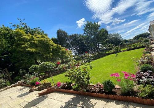 a garden with flowers and plants on a lawn at Stone House Hotel ‘A Bespoke Hotel’ in Stone