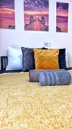 a bedroom with a bed with three pictures on the wall at PMP Adamia Apartments in Peyia