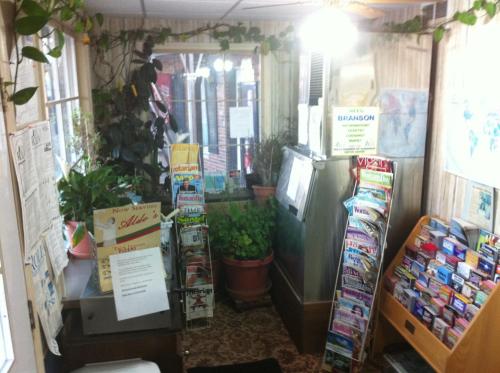 a store with a refrigerator and other items in a room at Rustic Motel Rolla in Rolla
