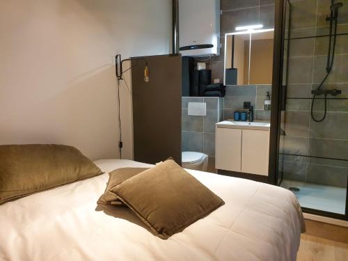 a bedroom with a white bed and a bathroom at City Stay&Go Enschede in Enschede