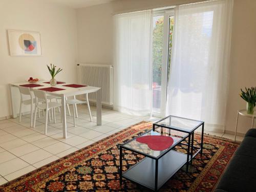 a living room with a table and a dining room at Appartamento con giardino al Melograno in Locarno