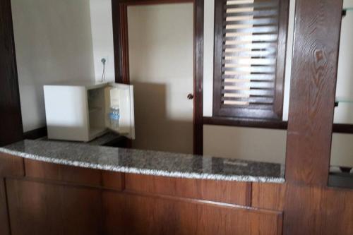 a kitchen with a counter top and a window at D Savoy 3 Bedroom Condo within Famosa Resort in Kampong Alor Gajah