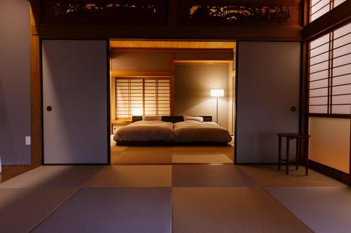 a bedroom with a bed inside of a room at Hakusyu - Vacation STAY 11460v in Aso