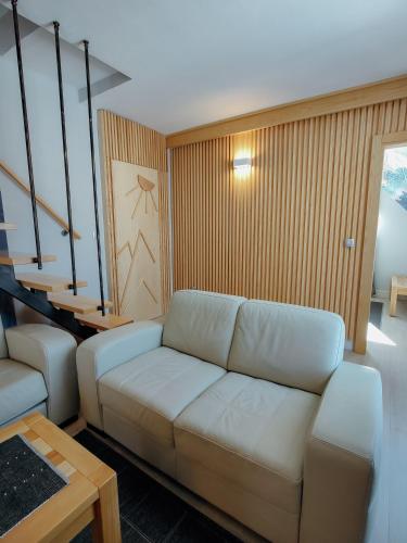 a living room with a white couch and a table at Casa di Pino EcoLodge Hotel in Žabljak
