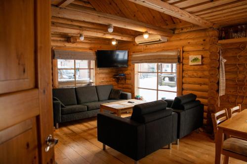 a living room with a couch and a table at Nuustakumajad in Otepää