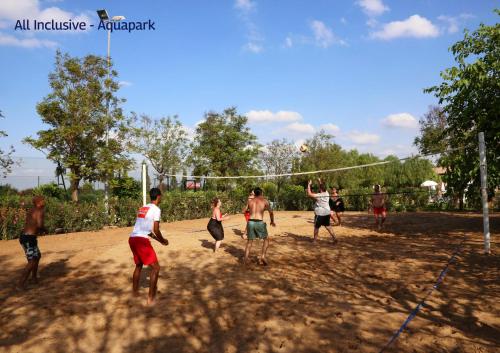 a group of young men playing a game of volleyball at Valeria Dar Atlas All Inclusive in Marrakech