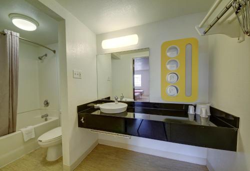 a bathroom with a sink and a toilet and a mirror at Motel 6-San Antonio, TX - Downtown - Market Square in San Antonio