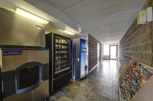 a hallway of a restaurant with a drink refrigerator at Motel 6-San Antonio, TX - Downtown - Market Square in San Antonio