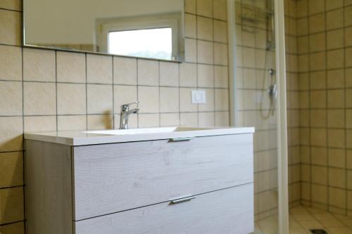 a bathroom with a white sink and a mirror at Le Voyageur Cilento in Vibonati