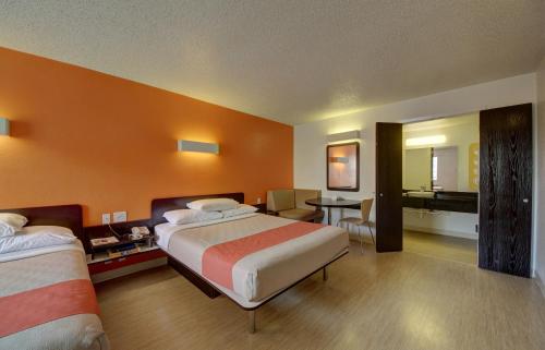 a hotel room with two beds and a bathroom at Motel 6-San Antonio, TX - Downtown - Market Square in San Antonio