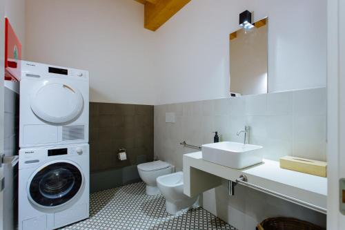 a bathroom with a washing machine and a washer at Dadi Home in Padova