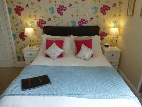 sypialnia z łóżkiem z książką w obiekcie Bryn Derwen Guest House w mieście Conwy