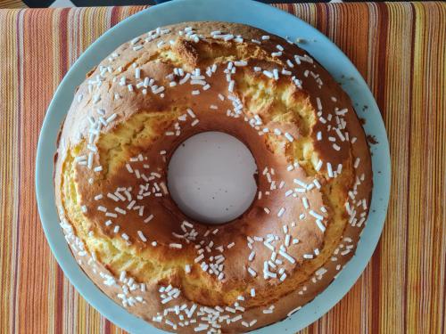 a glazed donut on a plate on a table at Albergo B&B Tenesi in Manerba del Garda
