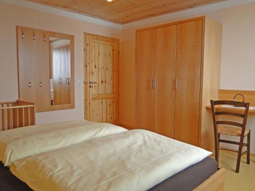 a bedroom with a bed and a chair in it at Birkholmhof in Bärnau