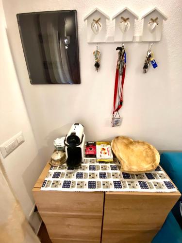 a dresser with a tv on top of it at Casa bouganville Vignola Mare in Vignola Mare