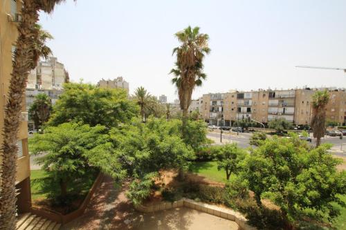 a view of a park with trees and buildings at Isramax 3BR apartment near the sea. in Bat Yam