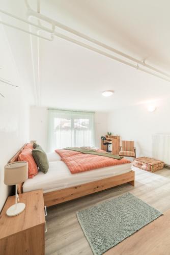 a bedroom with a large bed in a white room at Bah Apartment in Ljubljana